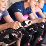 Close Up Of Group Taking Spin Class In Gym